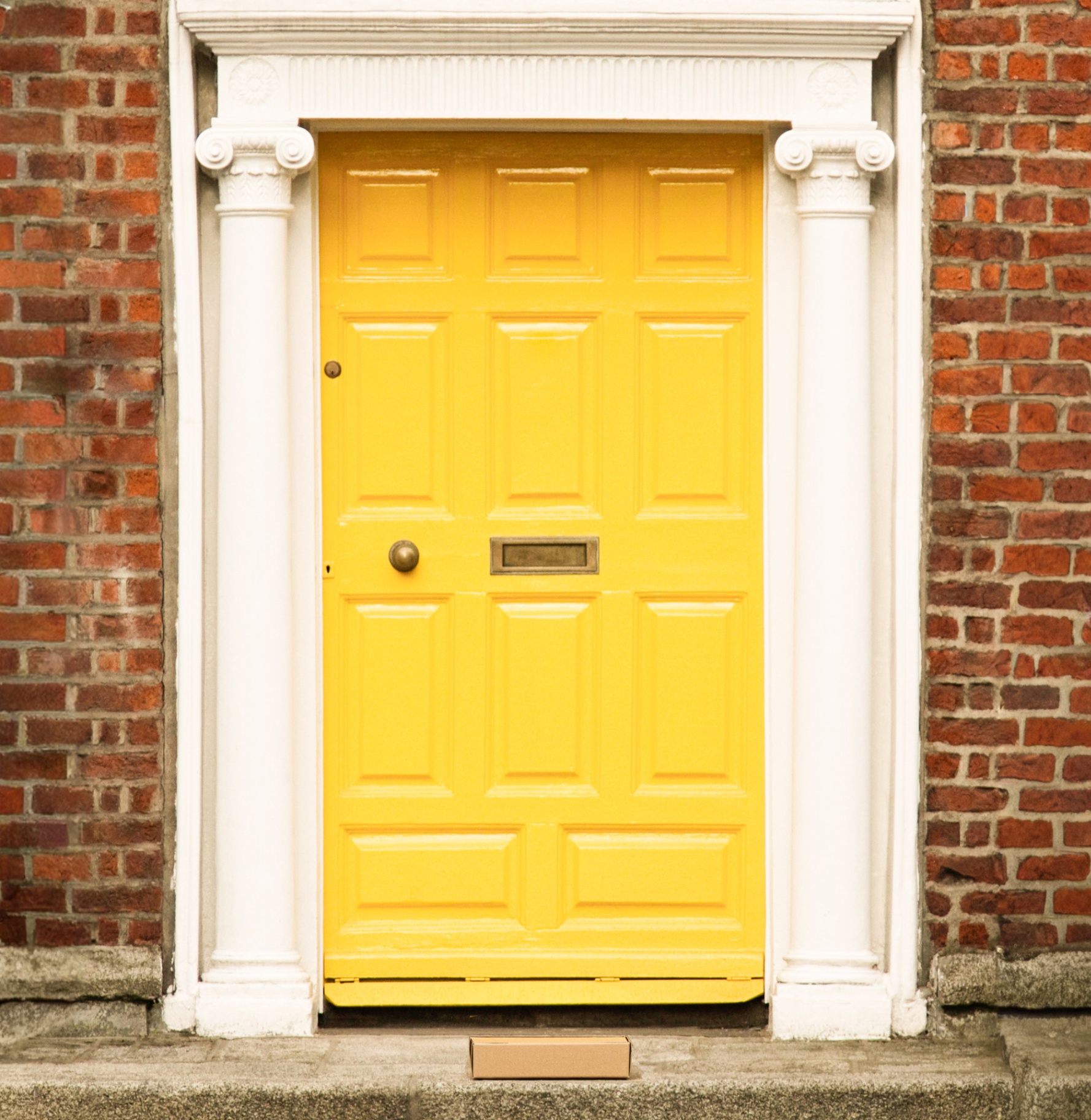Yellow Georgian front door with arched fanlight